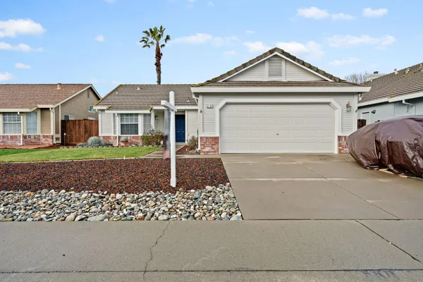 a front view of a house with a garden