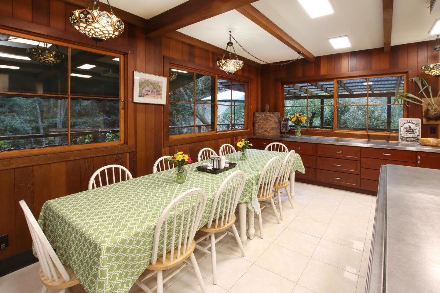 16770 Redwood Lodge Road Los Gatos, CA 95033 - Photo 106 of 122 a view of a dining room with furniture a chandelier and large windows