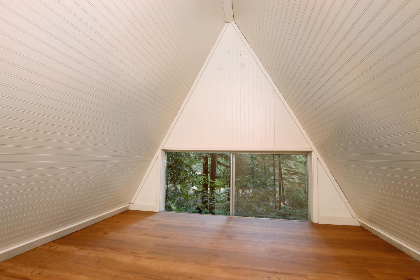 16770 Redwood Lodge Road Los Gatos, CA 95033 - Photo 18 of 122 a view of an empty room with wooden floor and a window