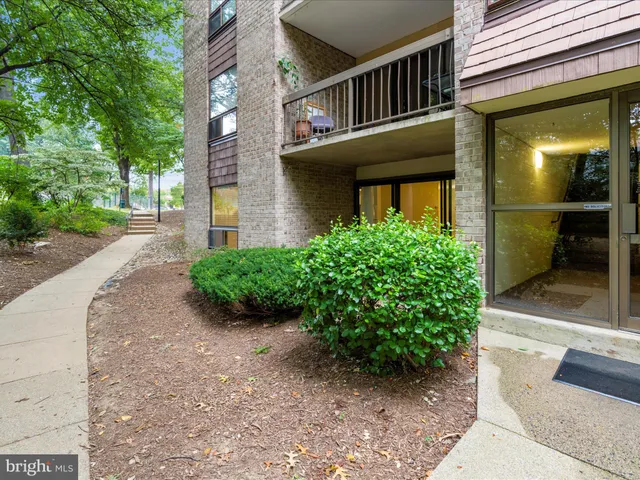 a view of a brick house with a yard
