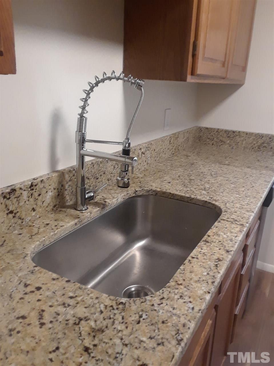 7762 Sandra Lane Raleigh, NC 27615 - Photo 2 of 9 a view of a kitchen counter top a sink and cabinets
