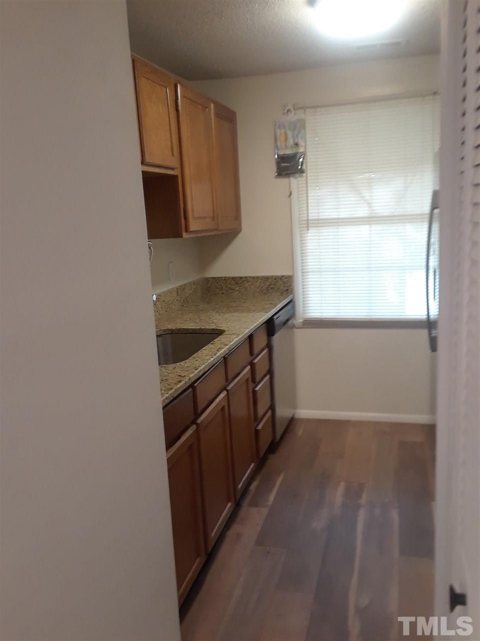 7762 Sandra Lane Raleigh, NC 27615 - Photo 5 of 9 a kitchen with a sink a stove and microwave
