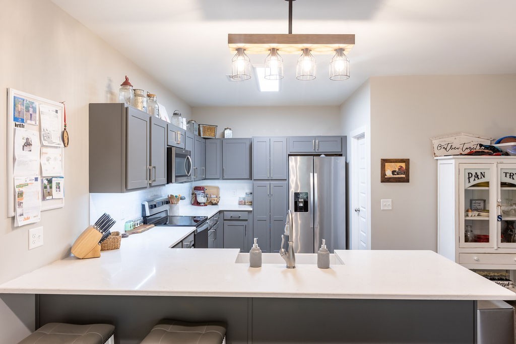 1578 Old Gallatin Road Portland, TN 37148 - Photo 13 of 32 a kitchen with kitchen island stainless steel appliances a refrigerator sink and cabinets