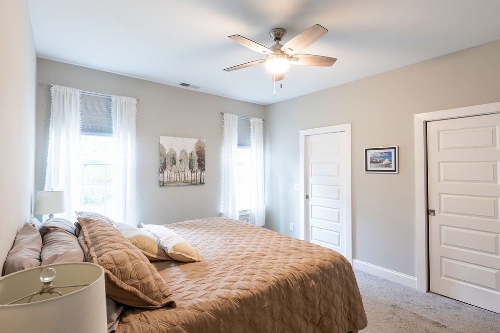 1578 Old Gallatin Road Portland, TN 37148 - Photo 18 of 32 a bedroom with a large bed and a ceiling fan