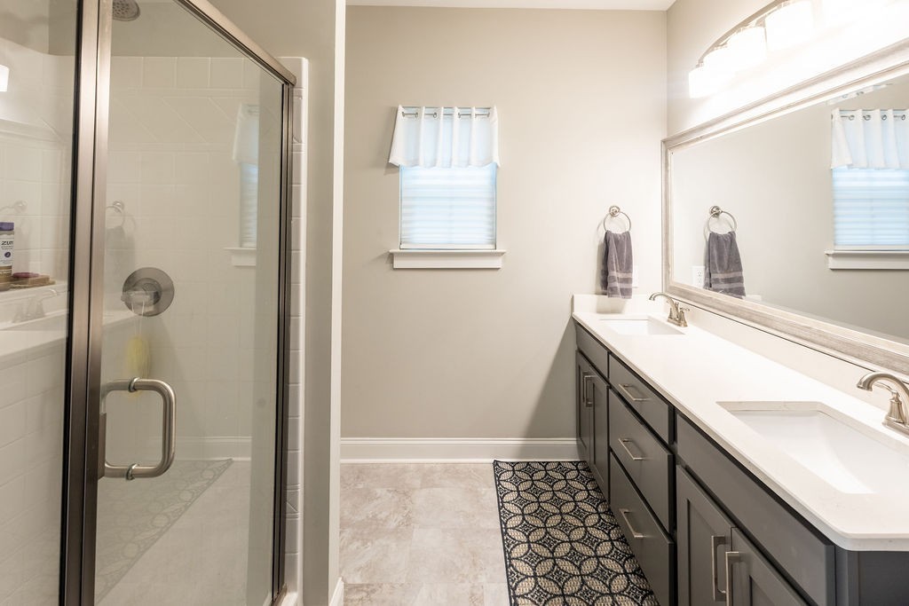 1578 Old Gallatin Road Portland, TN 37148 - Photo 21 of 32 a bathroom with a double vanity sink a mirror and shower