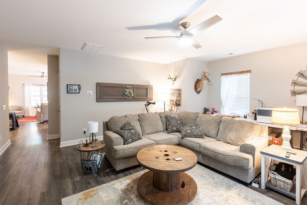 1578 Old Gallatin Road Portland, TN 37148 - Photo 23 of 32 a living room with furniture a fireplace and a chandelier