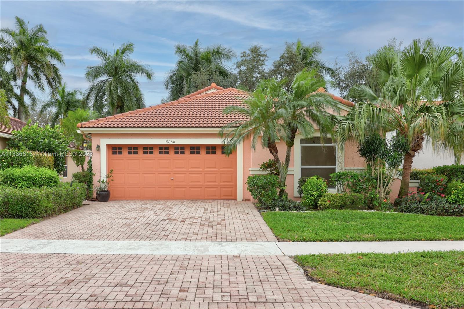 9650 Harbour Lake Circle Boynton Beach, FL 33437 - Photo 1 of 37 a front view of a house with a yard and garage