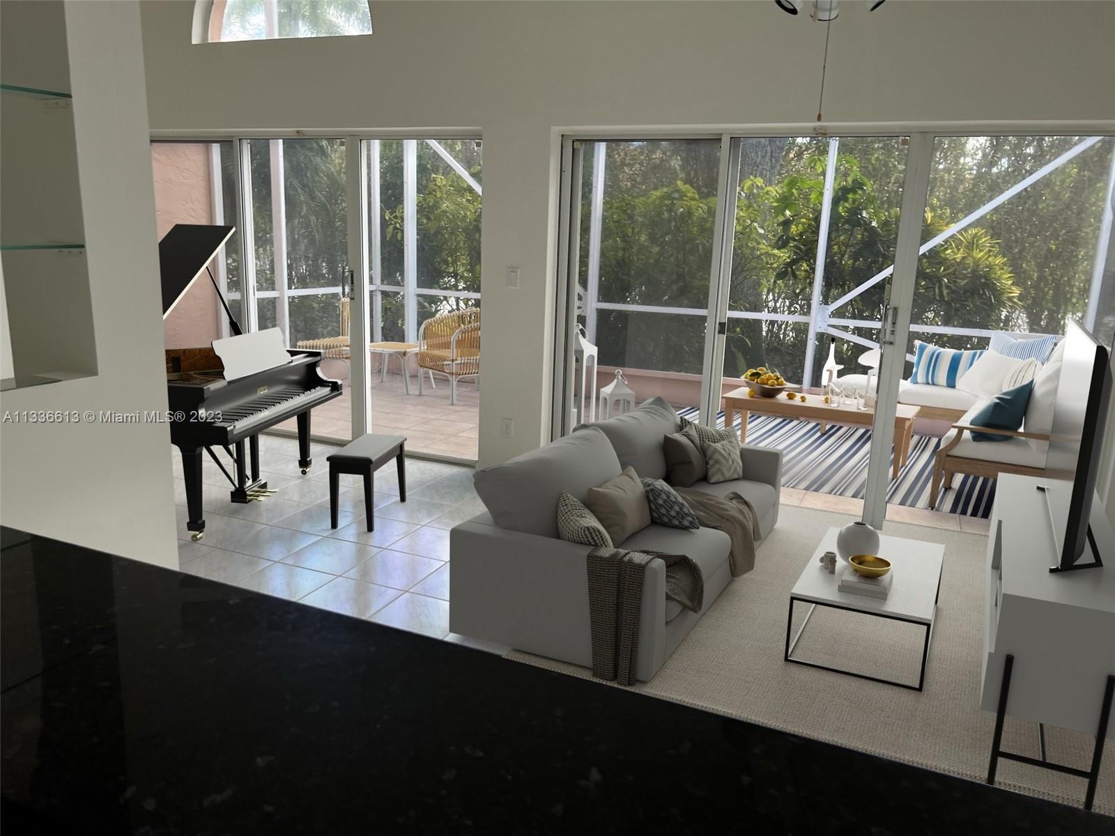 9650 Harbour Lake Circle Boynton Beach, FL 33437 - Photo 12 of 37 a living room with furniture tv and a large window