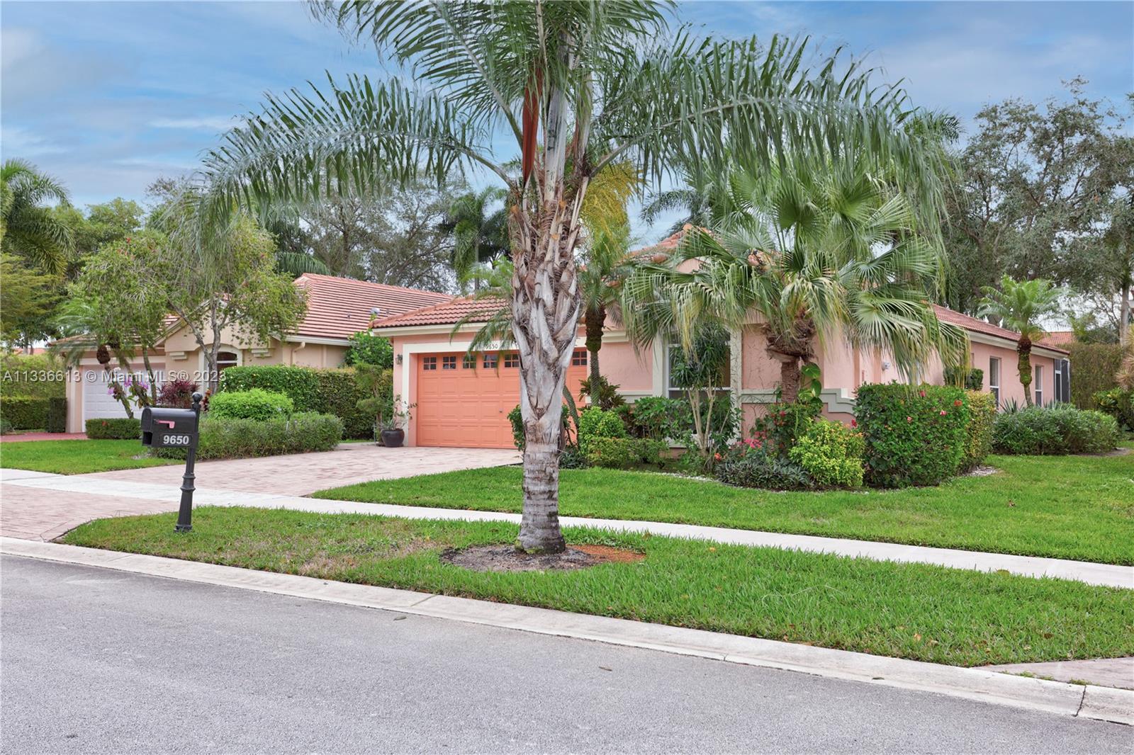 9650 Harbour Lake Circle Boynton Beach, FL 33437 - Photo 2 of 37 a sign board with flower plants and big trees