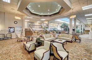 9650 Harbour Lake Circle Boynton Beach, FL 33437 - Photo 30 of 37 a living room with lots of chairs and a chandelier