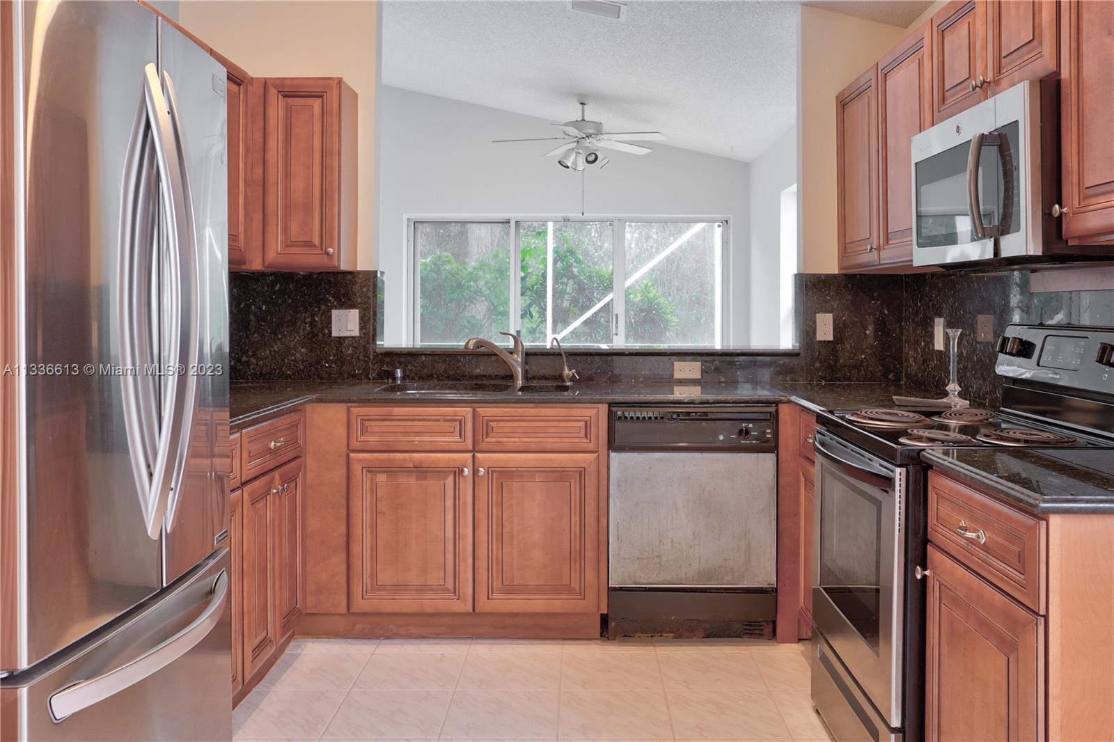 9650 Harbour Lake Circle Boynton Beach, FL 33437 - Photo 8 of 37 a kitchen with stainless steel appliances granite countertop a refrigerator sink and stove