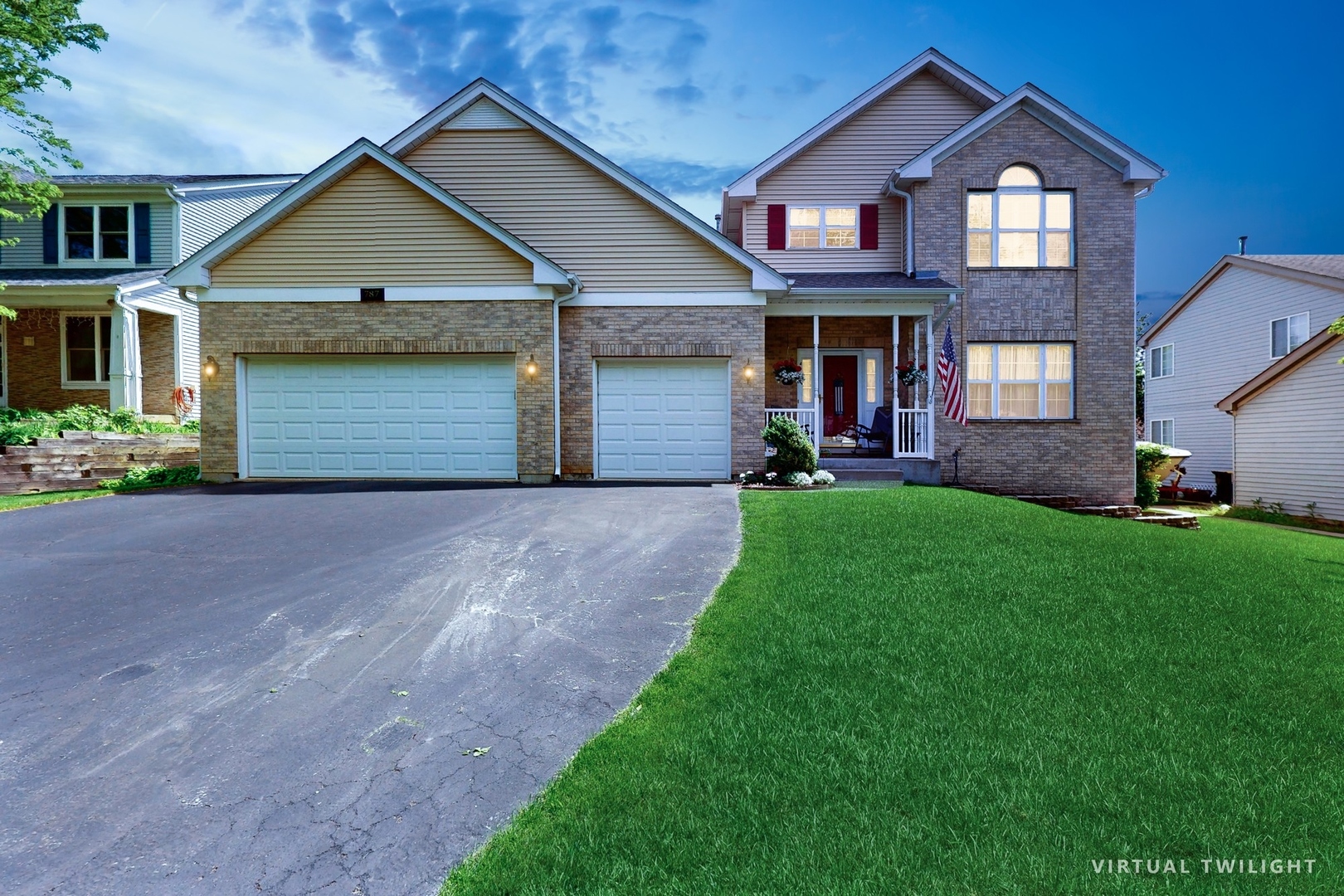 a front view of a house with a yard and garage