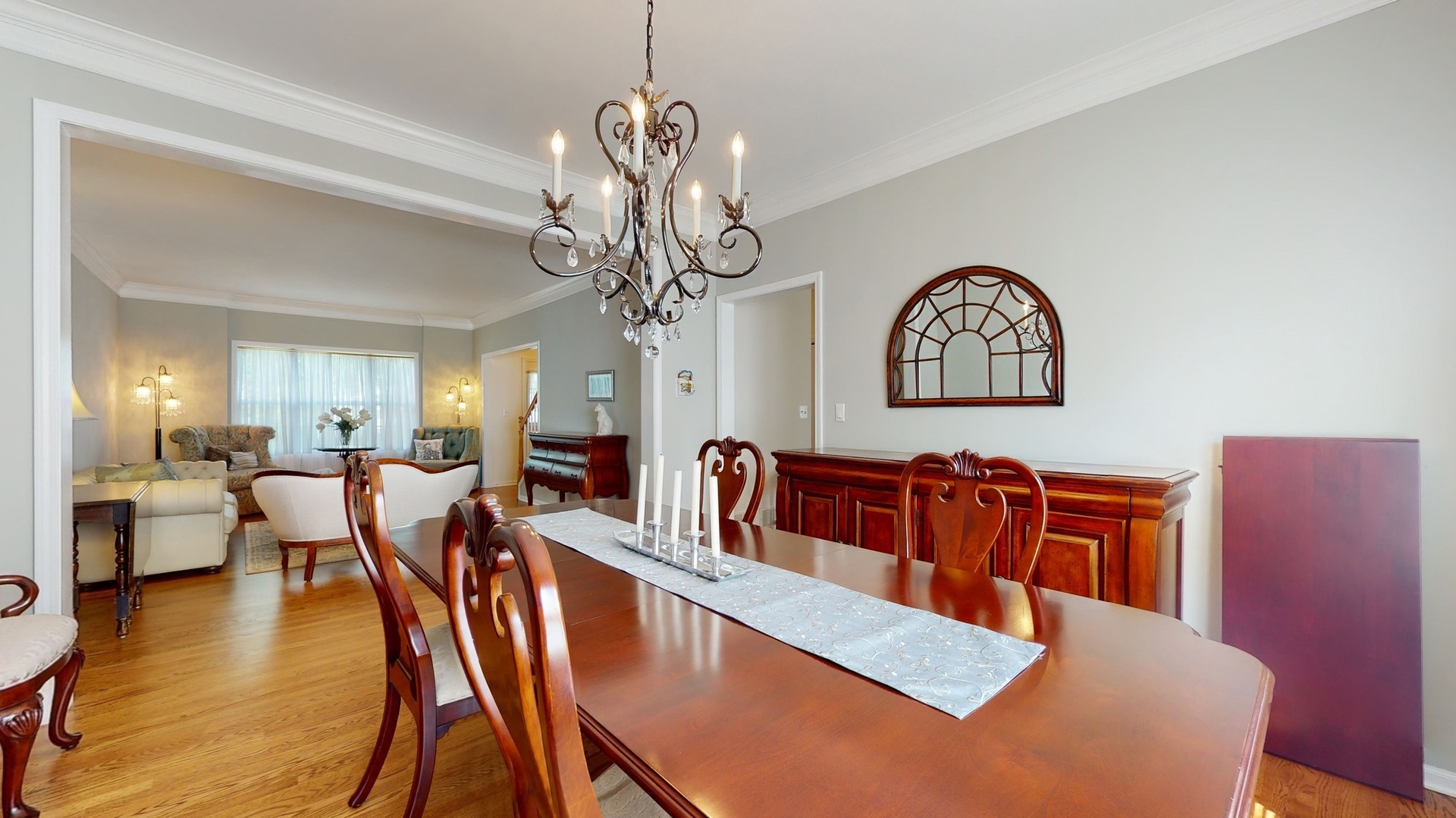 787 Laurel Lane Cary, IL 60013 - Photo 11 of 37 a living room with couches a dining table and chairs with wooden floor