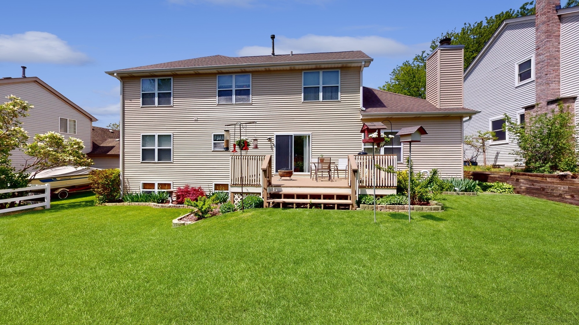 787 Laurel Lane Cary, IL 60013 - Photo 34 of 37 a white house that has a small yard and trees in the background