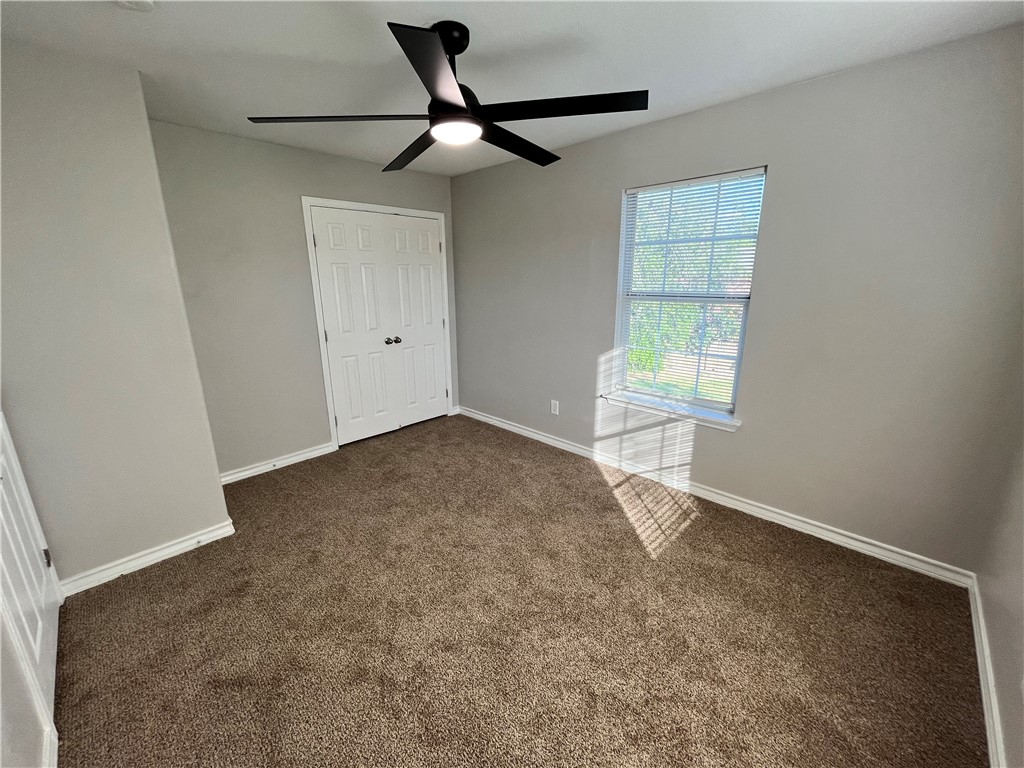 908 East Hefferman Street Beeville, TX 78102 - Photo 27 of 40 an empty room with windows and fan
