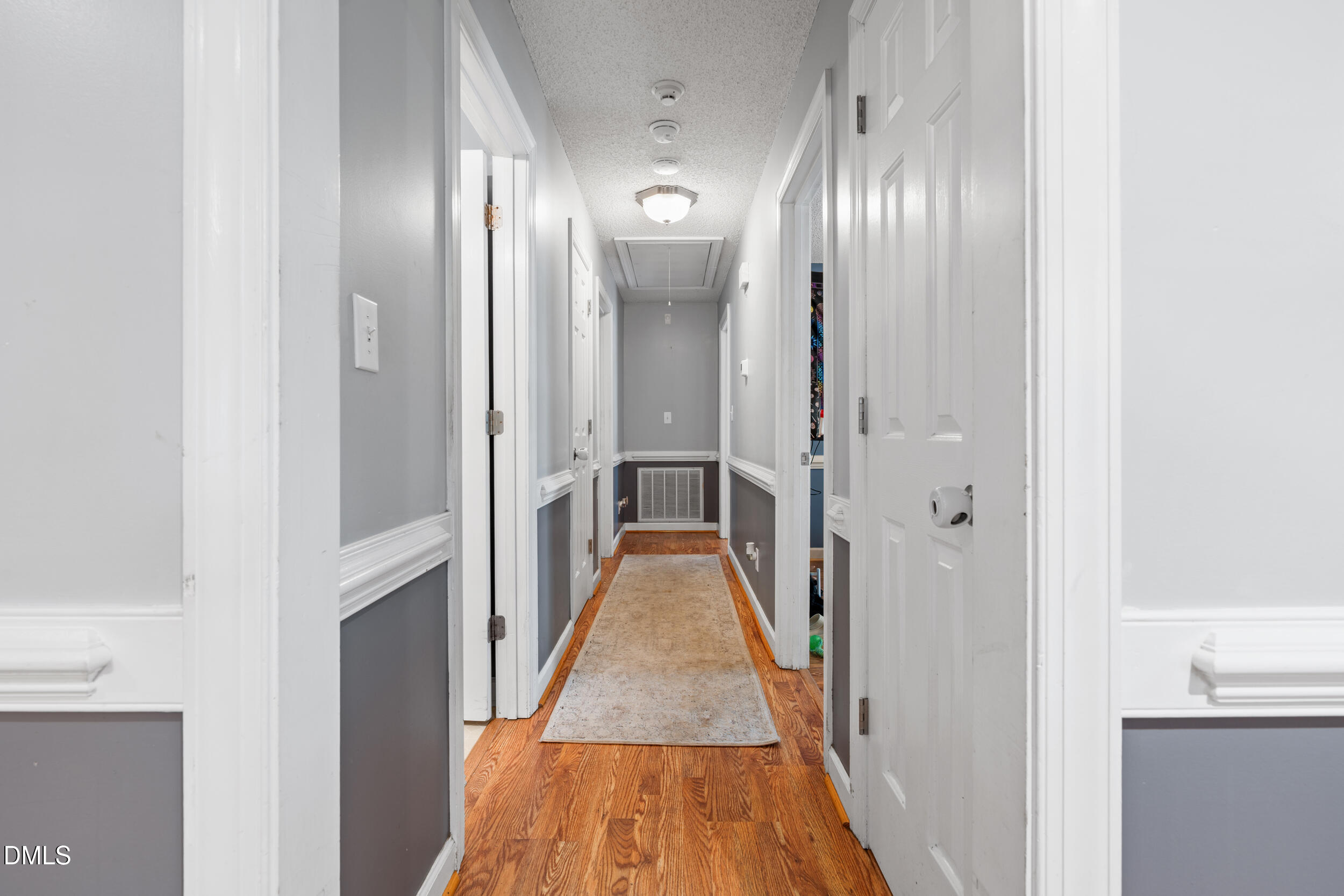 311 Bridgers Road Kenly, NC 27542 - Photo 17 of 46 a view of a hallway with wooden floor and a bathroom