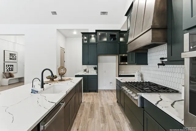 a kitchen with a sink stainless steel appliances and cabinets