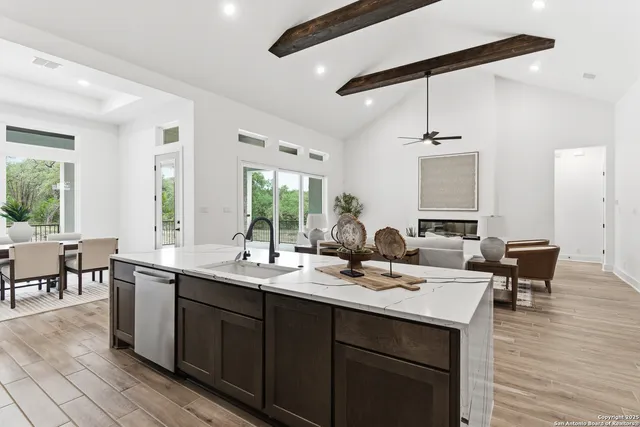 a kitchen with a sink appliances and a dining table