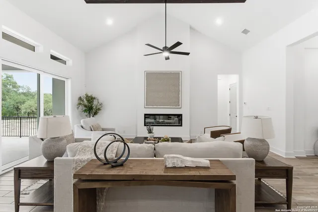 a living room with furniture a chandelier and a window