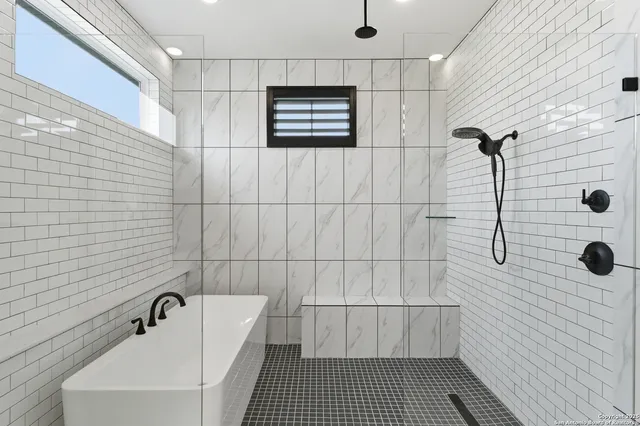 a bathroom with a bathtub and shower