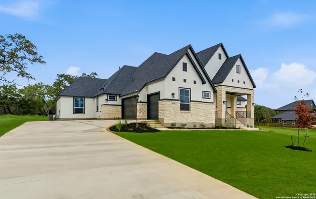 a front view of a house with a yard and garage