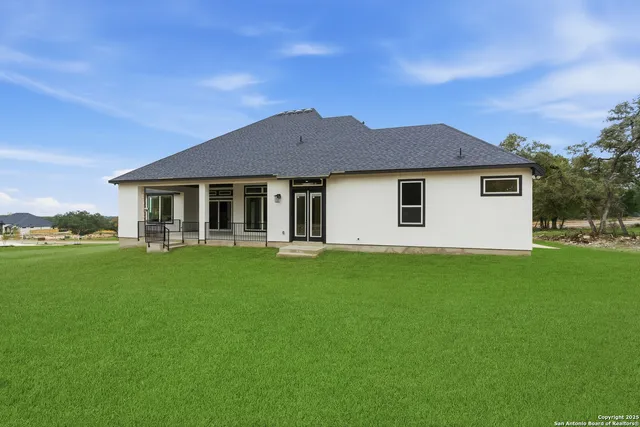 a front view of a house with a yard and porch