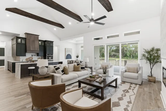 a living room with fireplace furniture and a large window
