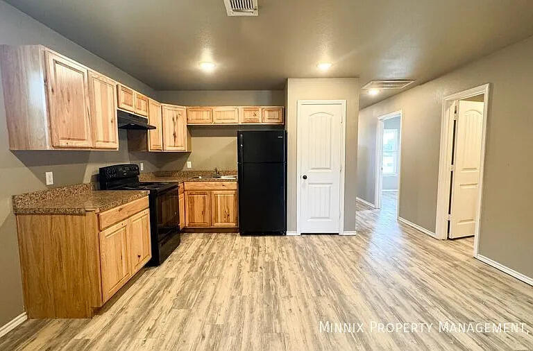 517 44th Street Lubbock, TX 79404 - Photo 7 of 10 a kitchen with granite countertop a refrigerator stove top oven and sink
