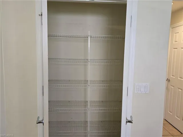 a view of an empty room with a floor to ceiling window