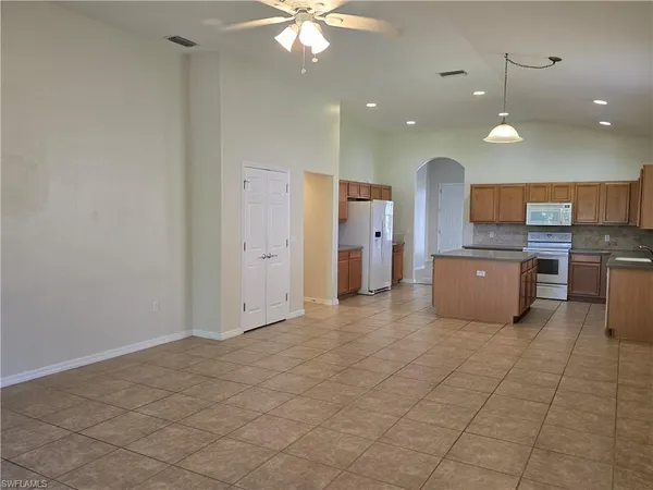 a open kitchen with cabinets and stainless steel appliances