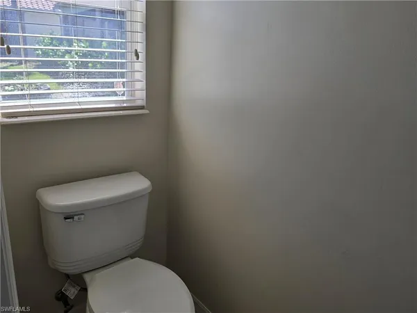 a view of empty room with a ceiling fan and window