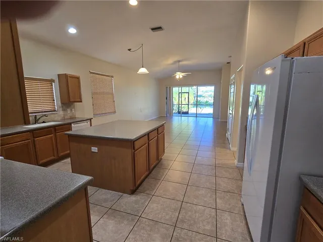 a open kitchen with cabinets and stainless steel appliances