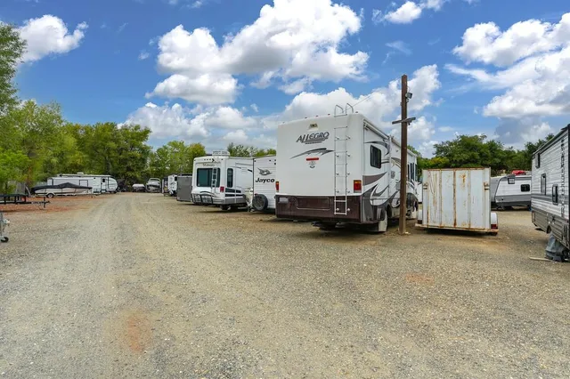a view of a cars park in front of a building