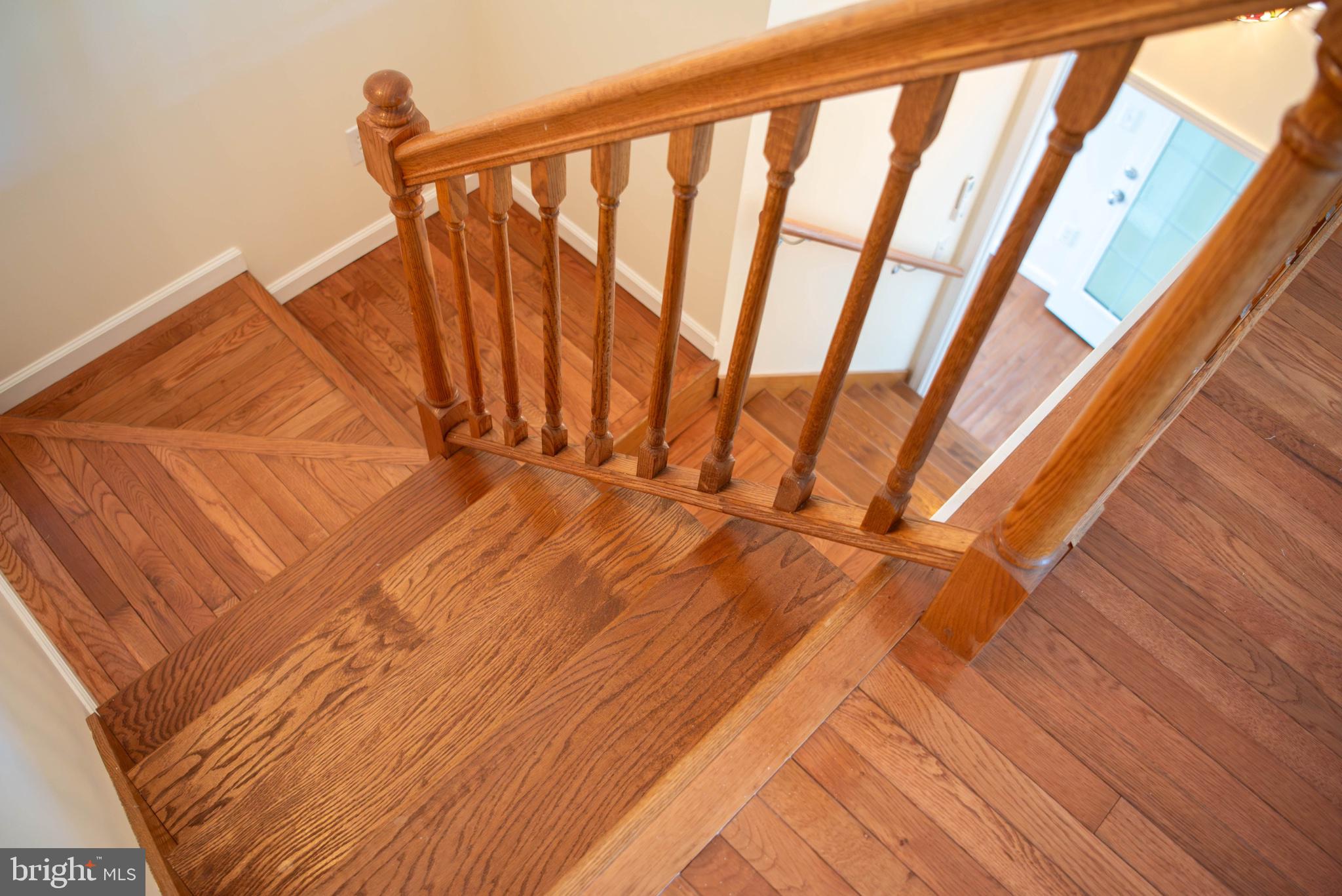 792 Forest Glen Road Moorefield, WV 26836 - Photo 103 of 146 Elegant wooden staircase invites ascent.