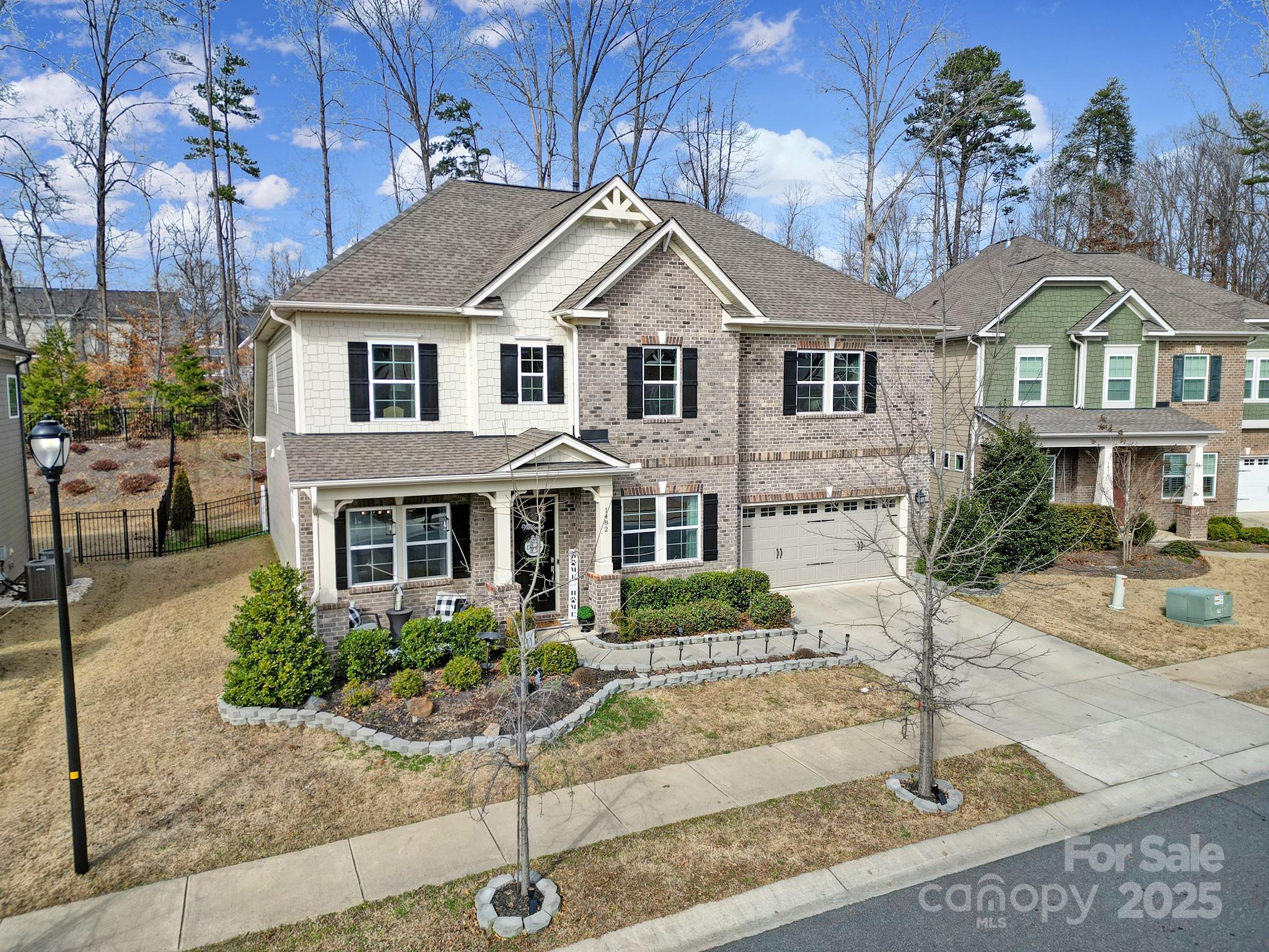 1482 Afton Way Fort Mill, SC 29708 - Photo 11 of 11 a view of a white house with large windows and a small yard
