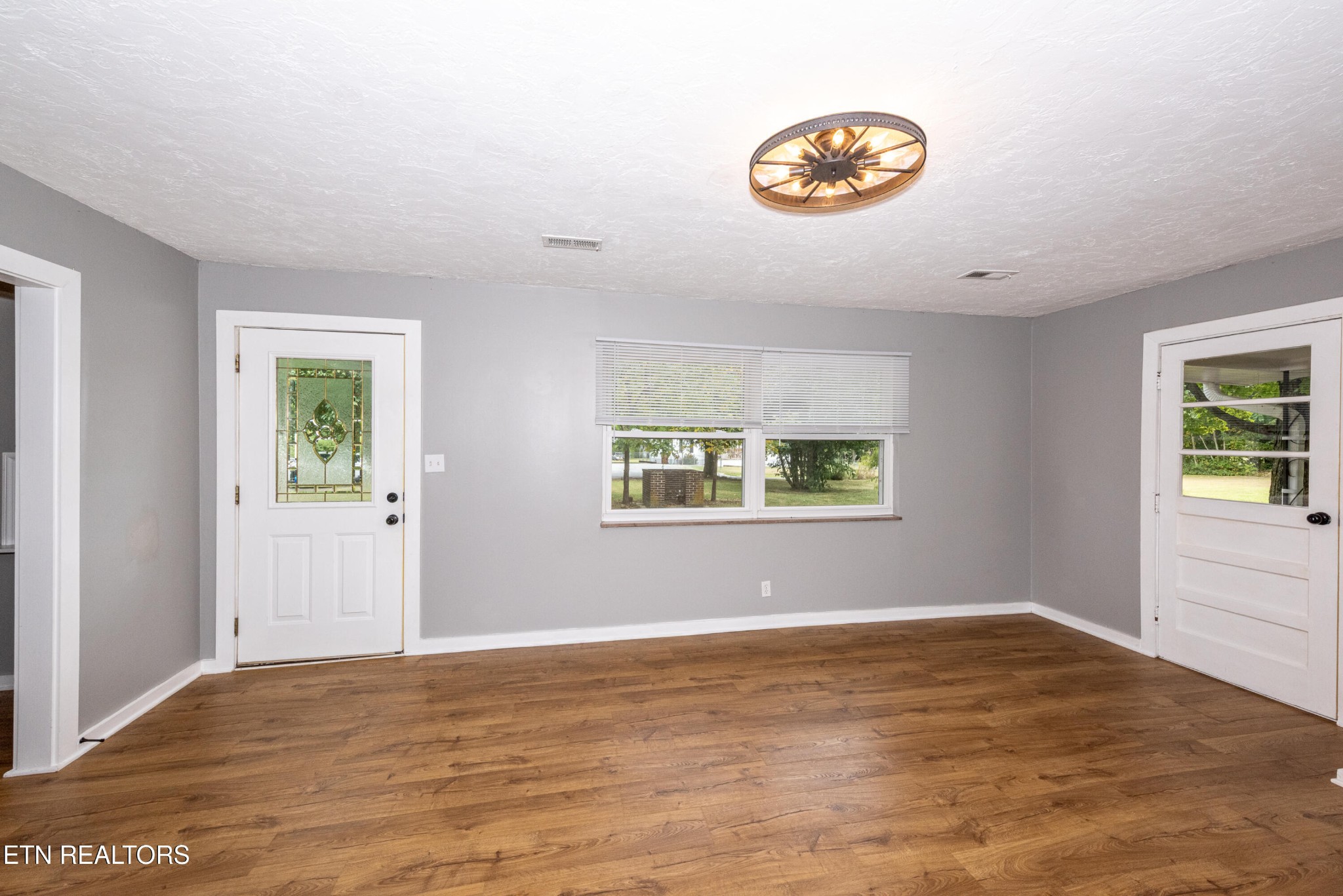 149 Moat Sewell Road Philadelphia, TN 37846 - Photo 31 of 35 a view of an empty room with window and wooden floor