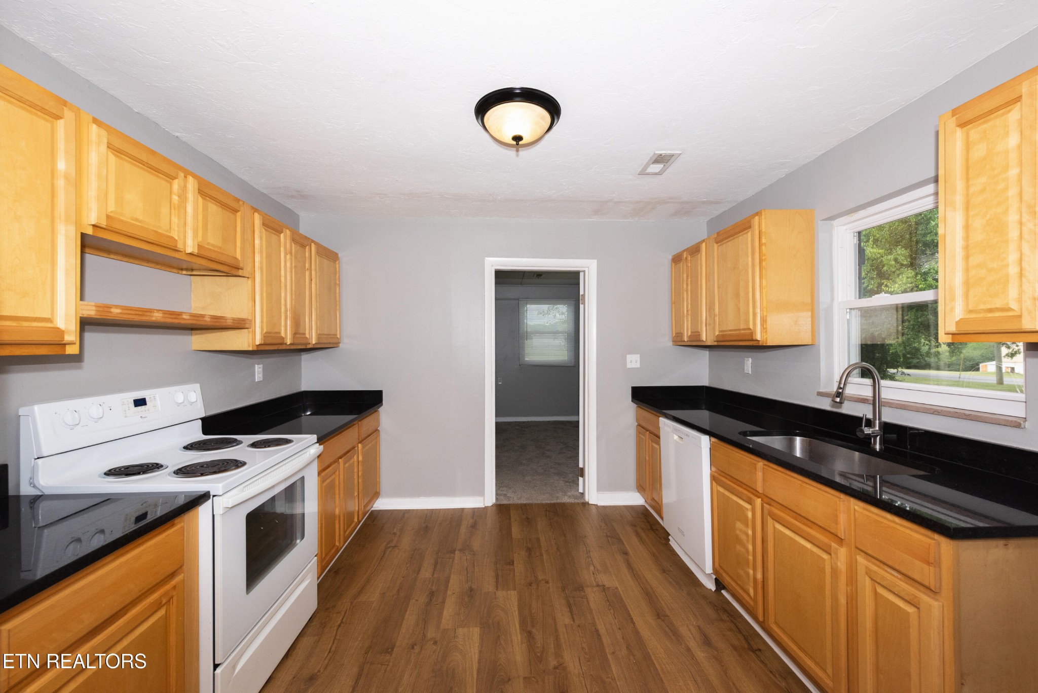 149 Moat Sewell Road Philadelphia, TN 37846 - Photo 6 of 35 a kitchen with stainless steel appliances granite countertop a stove a sink and a microwave