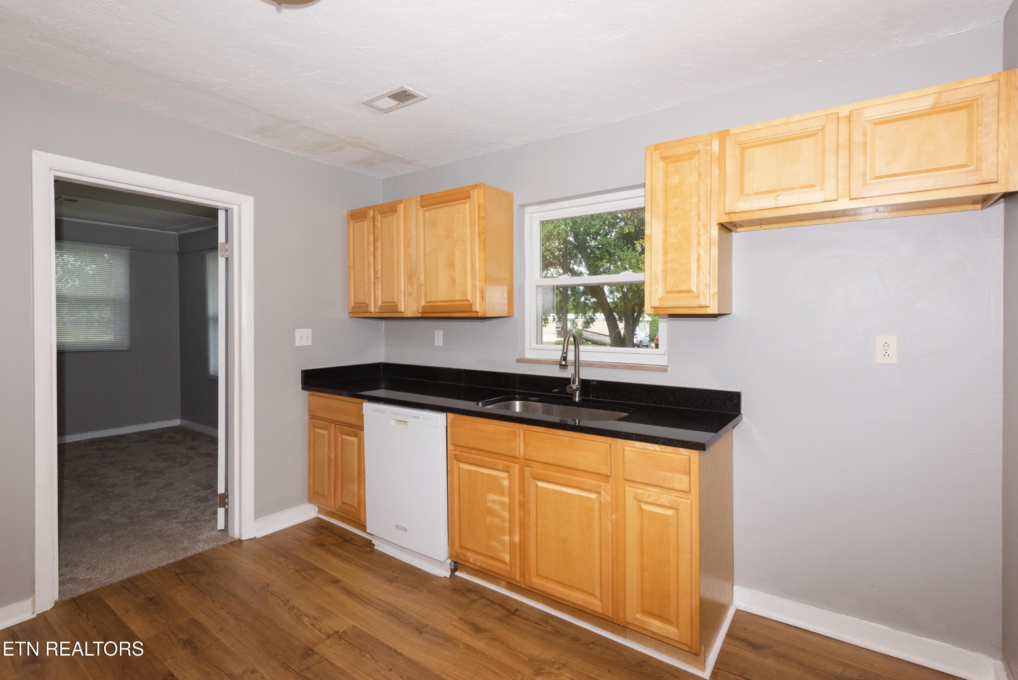 149 Moat Sewell Road Philadelphia, TN 37846 - Photo 8 of 35 a kitchen with granite countertop a sink and a window