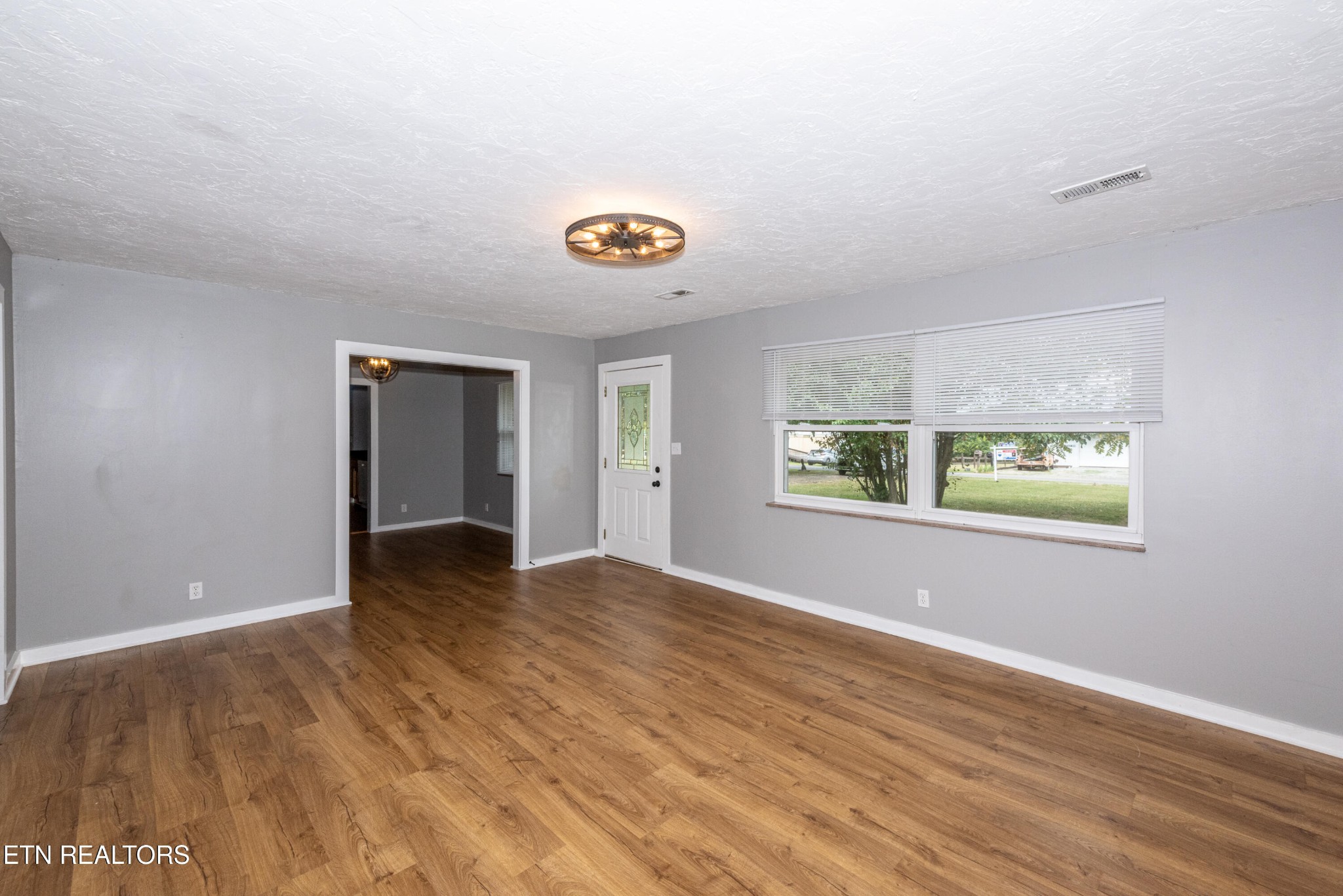 149 Moat Sewell Road Philadelphia, TN 37846 - Photo 9 of 35 a view of an empty room with window and wooden floor