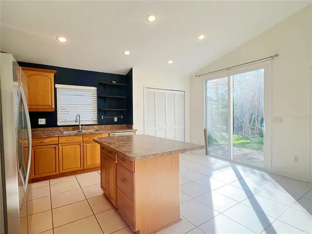 a kitchen with stainless steel appliances granite countertop a sink and a stove