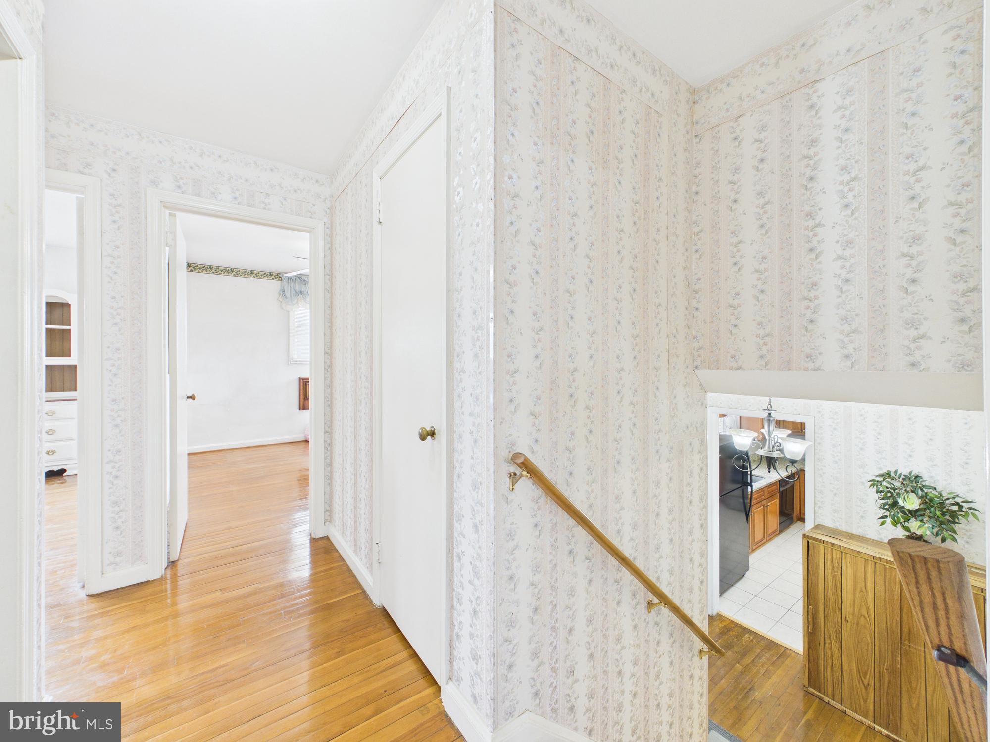 5907 Camberly Avenue Springfield, VA 22150 - Photo 21 of 41 a view of a hallway with wooden floor and staircase