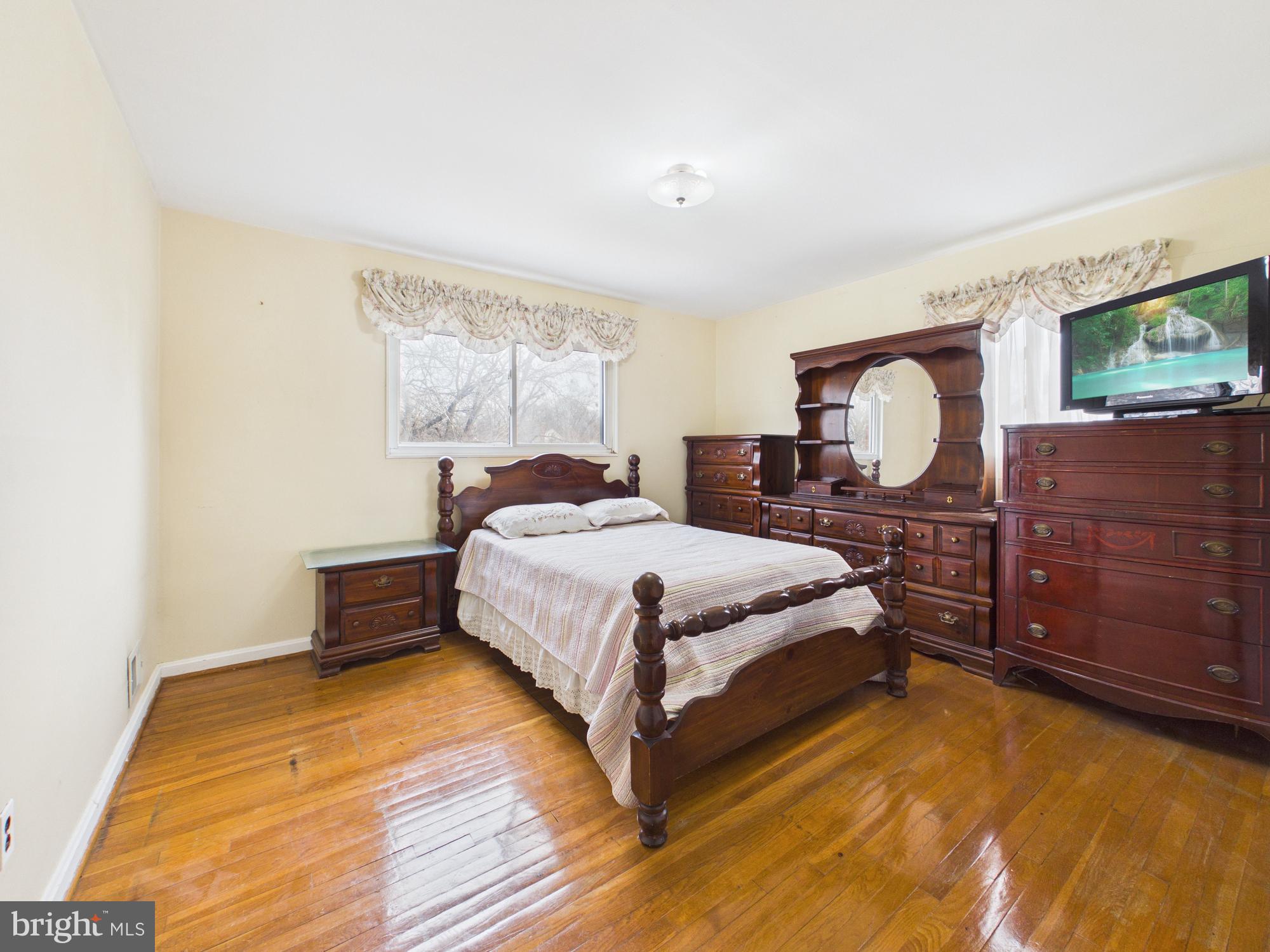 5907 Camberly Avenue Springfield, VA 22150 - Photo 22 of 41 a bedroom with a bed and wooden floor