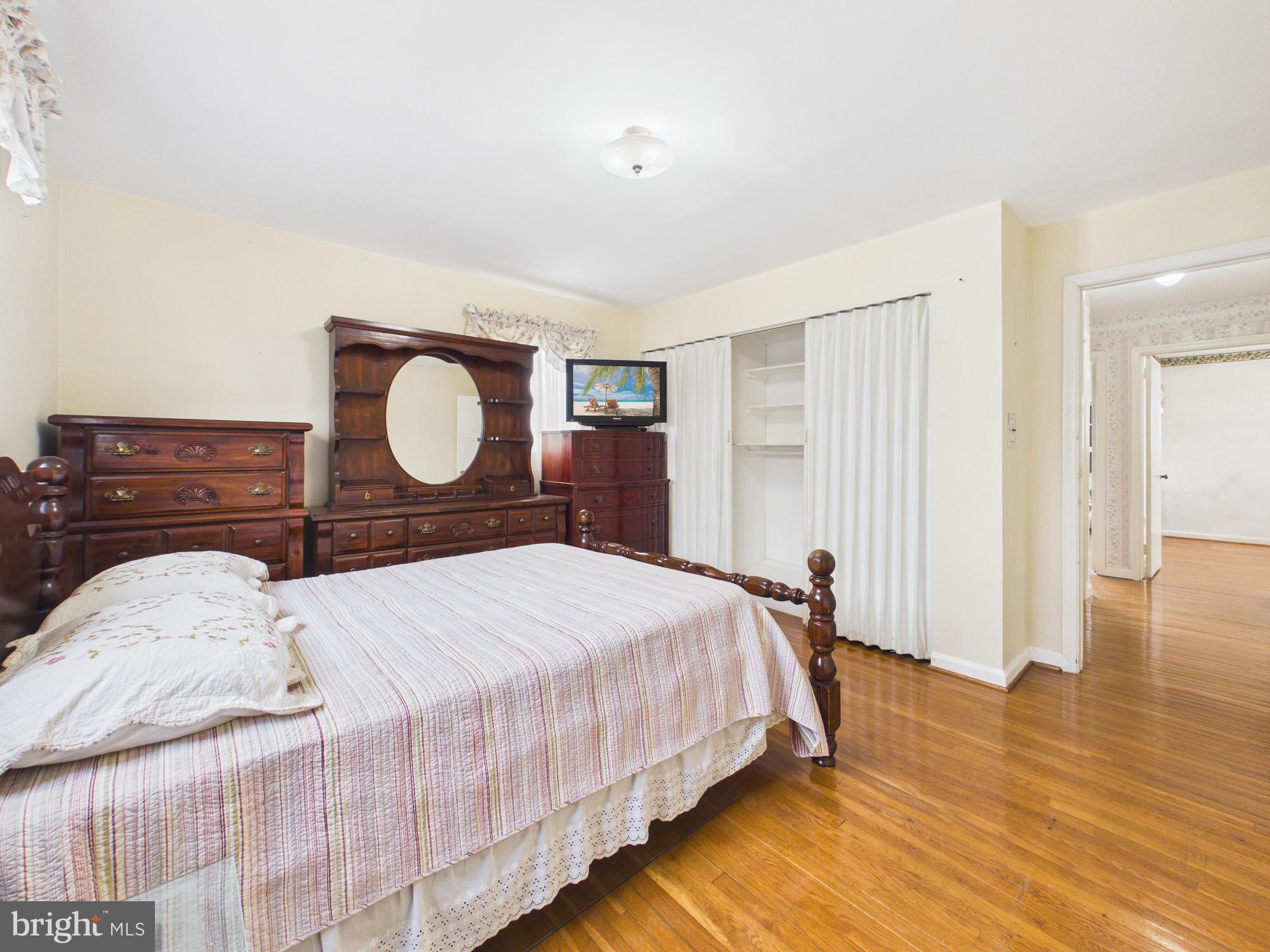 5907 Camberly Avenue Springfield, VA 22150 - Photo 23 of 41 a bedroom with a bed and wooden floor
