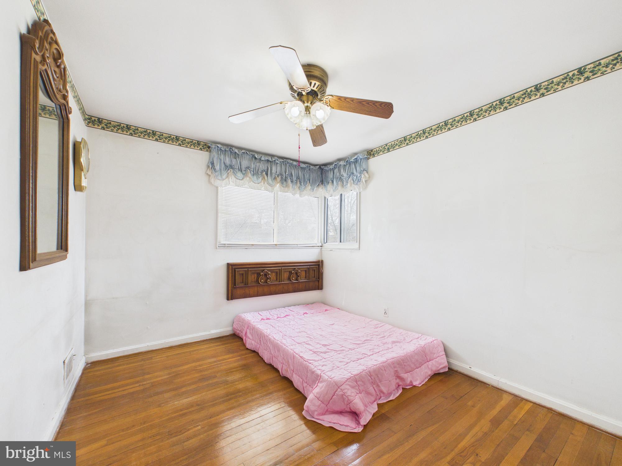 5907 Camberly Avenue Springfield, VA 22150 - Photo 26 of 41 a bedroom with a bed and a chandelier