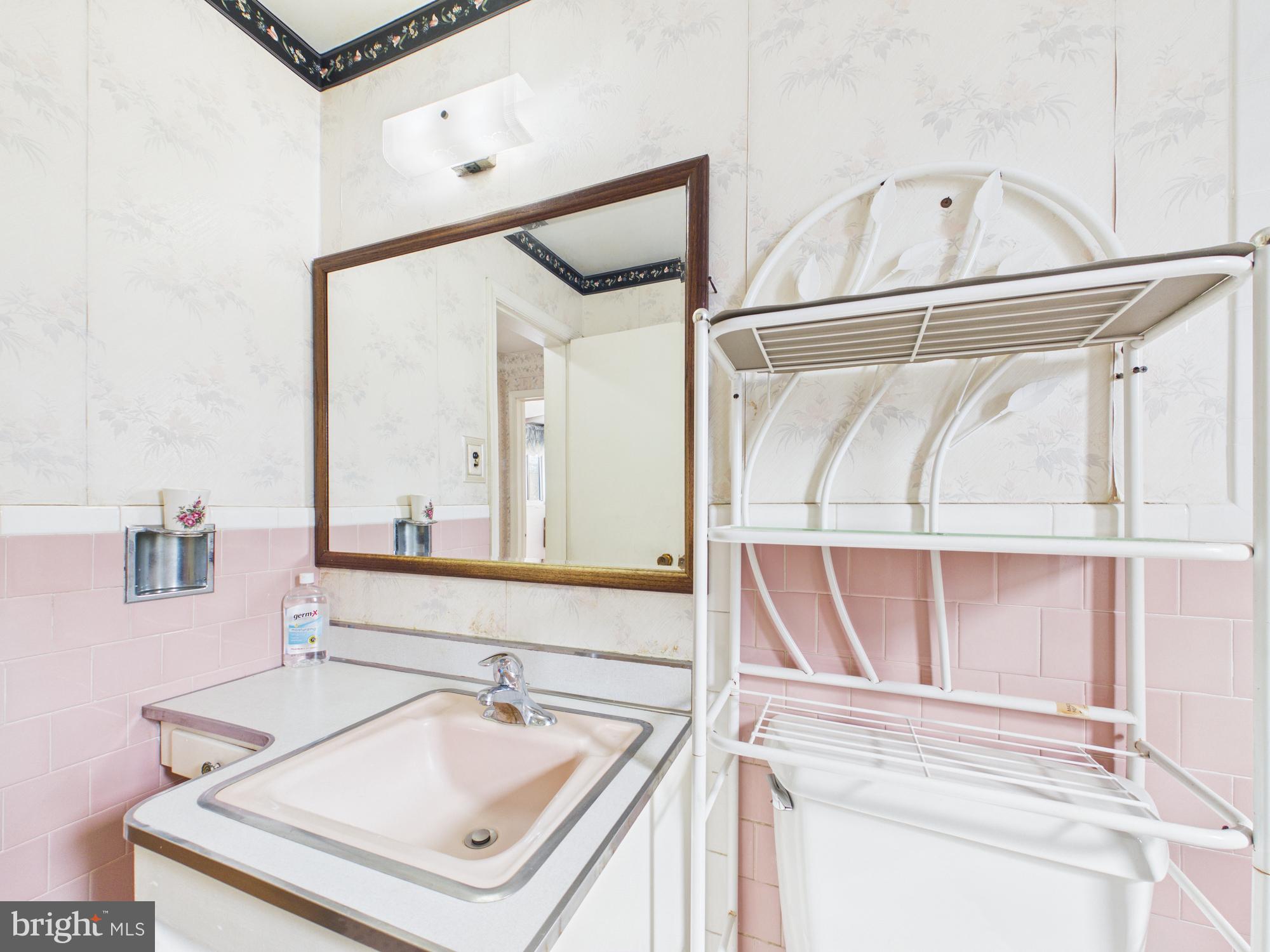 5907 Camberly Avenue Springfield, VA 22150 - Photo 28 of 41 a bathroom with a sink a vanity and a mirror