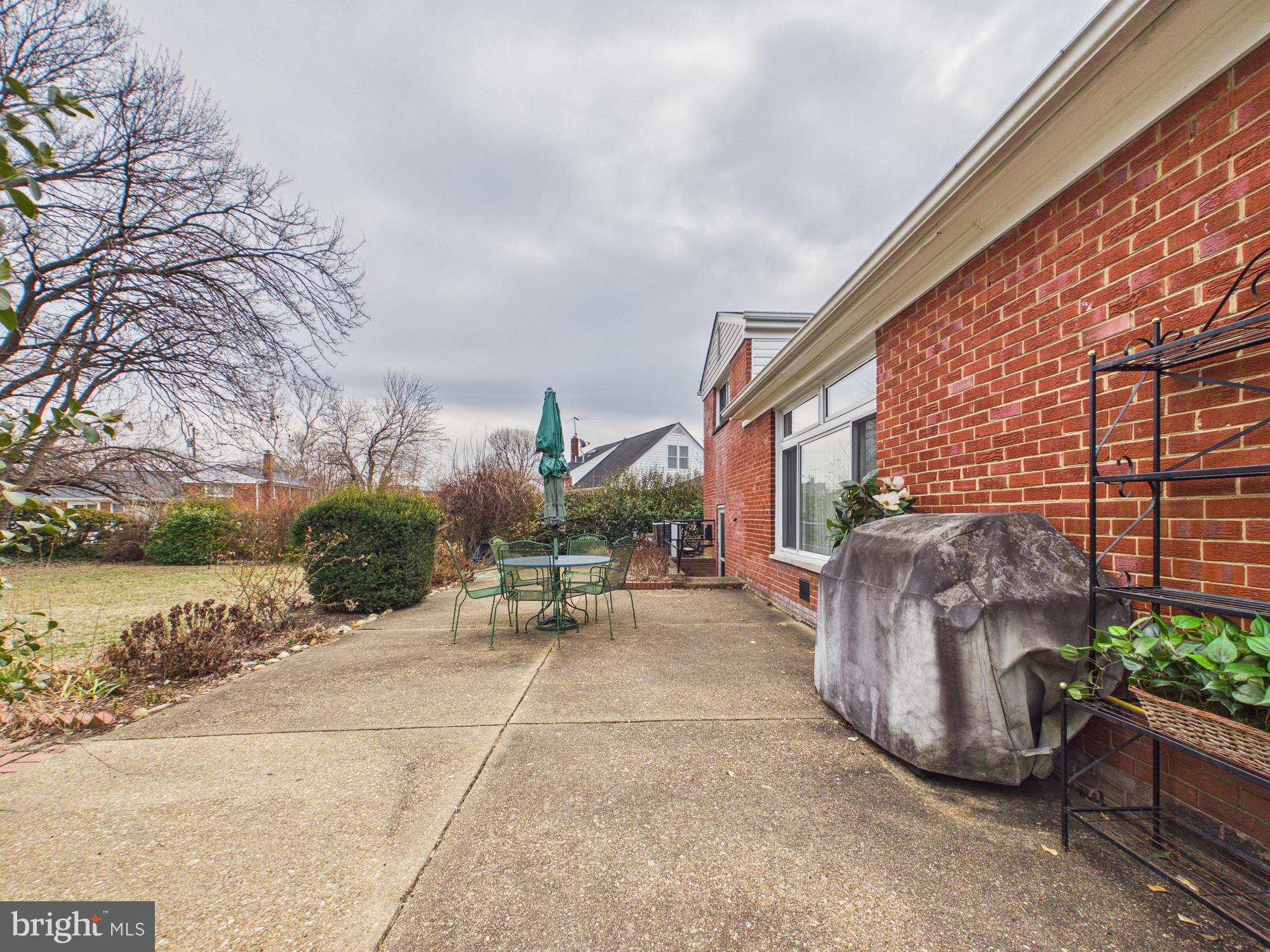 5907 Camberly Avenue Springfield, VA 22150 - Photo 31 of 41 a view of a patio with a table and chairs under an umbrella