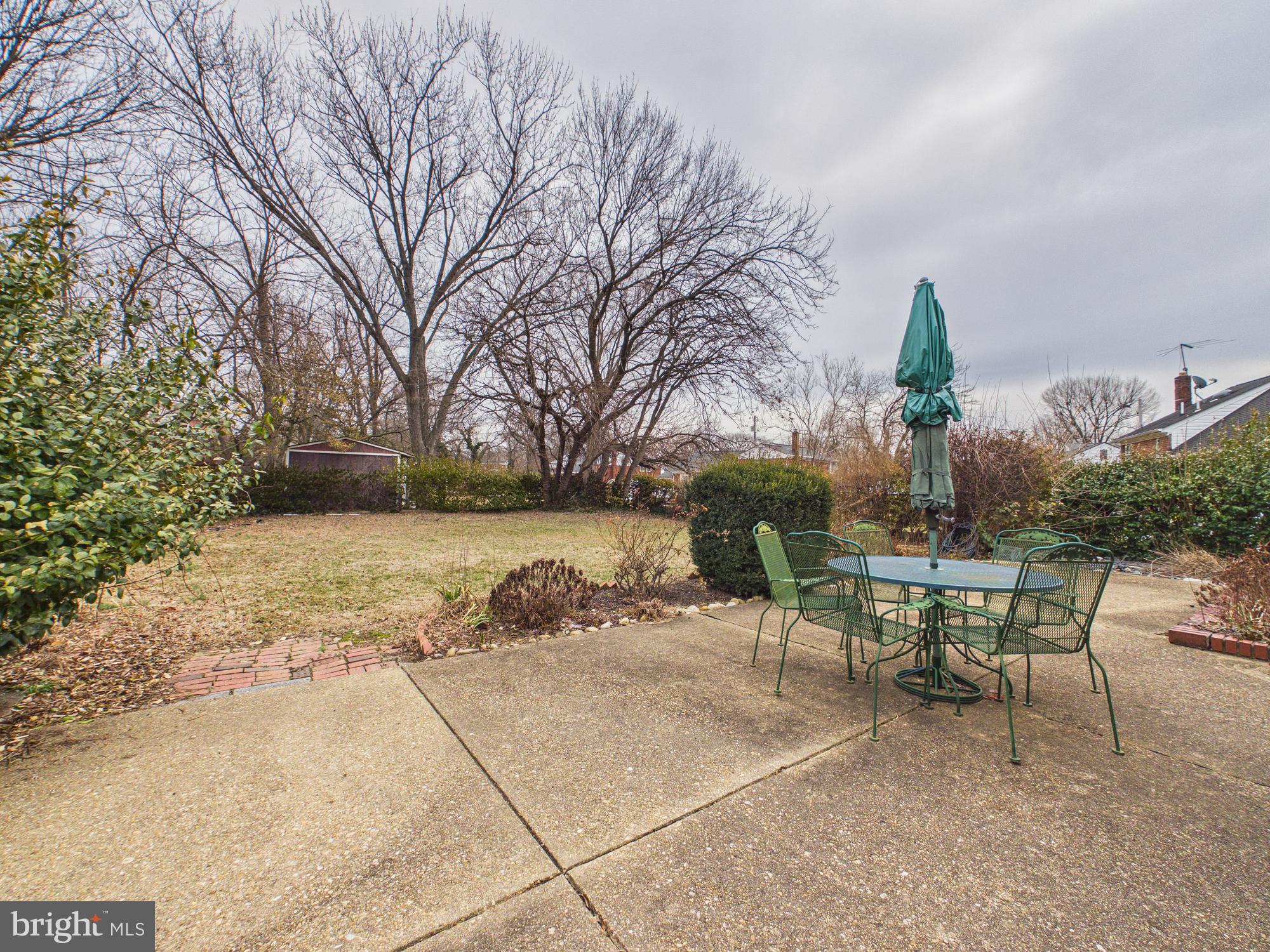 5907 Camberly Avenue Springfield, VA 22150 - Photo 34 of 41 a view of a yard with table and chairs and potted plants