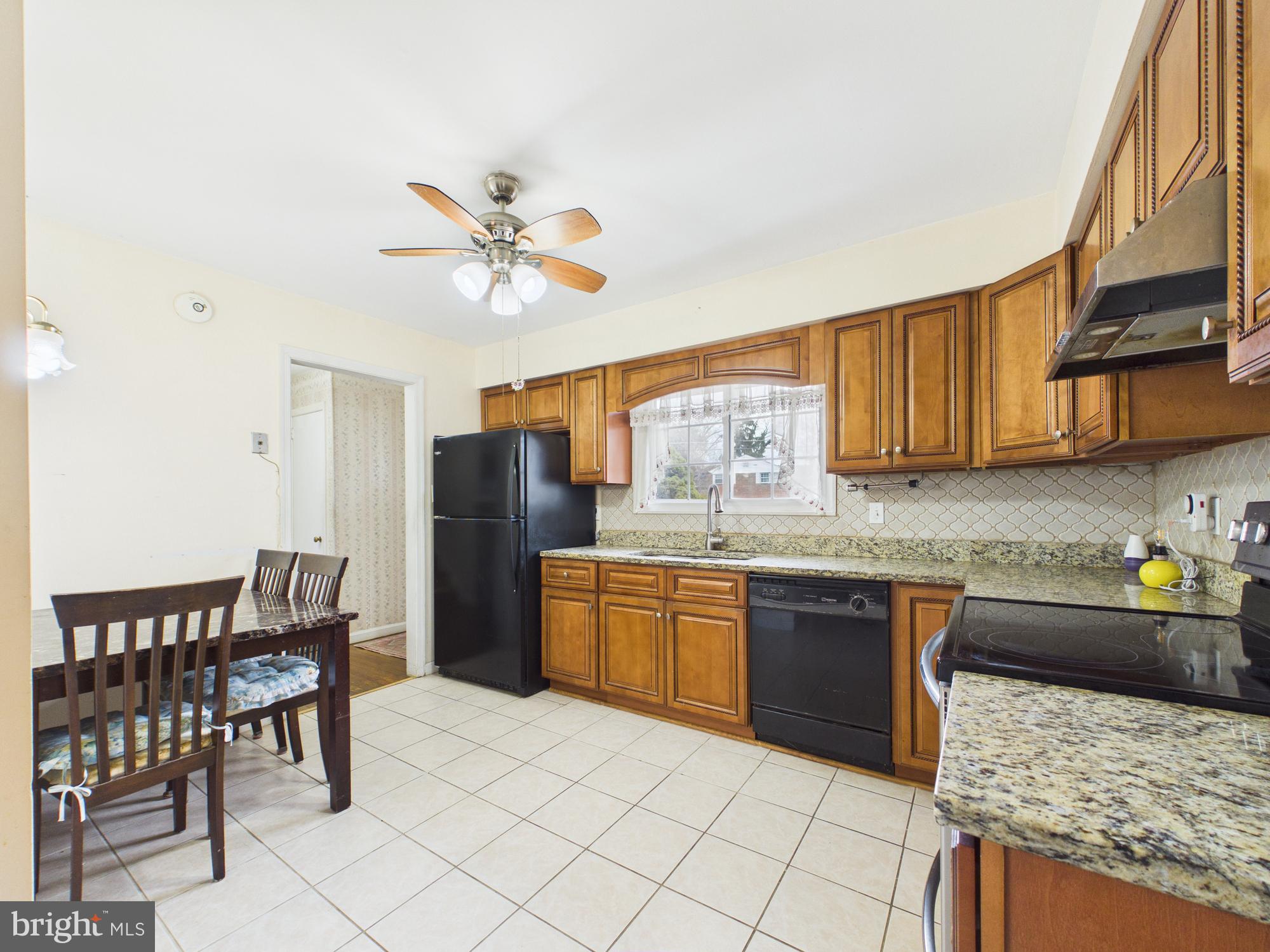 5907 Camberly Avenue Springfield, VA 22150 - Photo 5 of 41 a kitchen with a stove a sink and a refrigerator