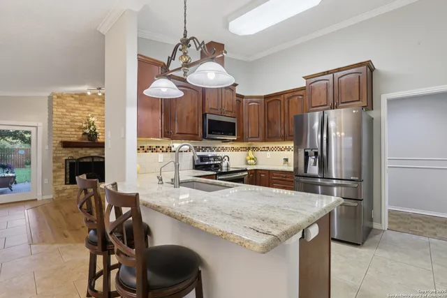 a kitchen with a table chairs refrigerator and microwave
