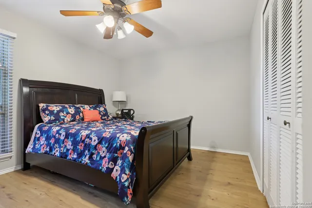 a bed sitting in a bedroom next to a lamp